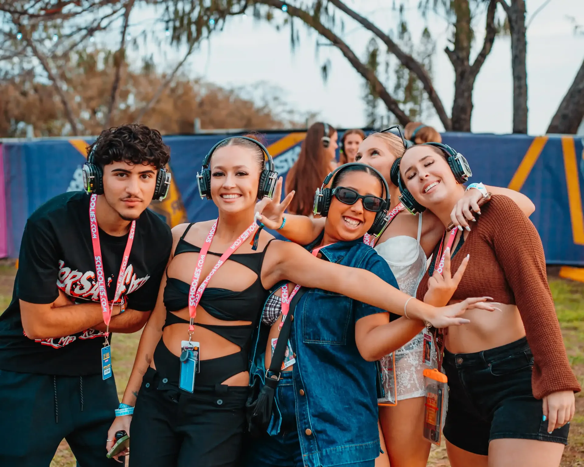 A group of people wearing headphones are posing for a picture.