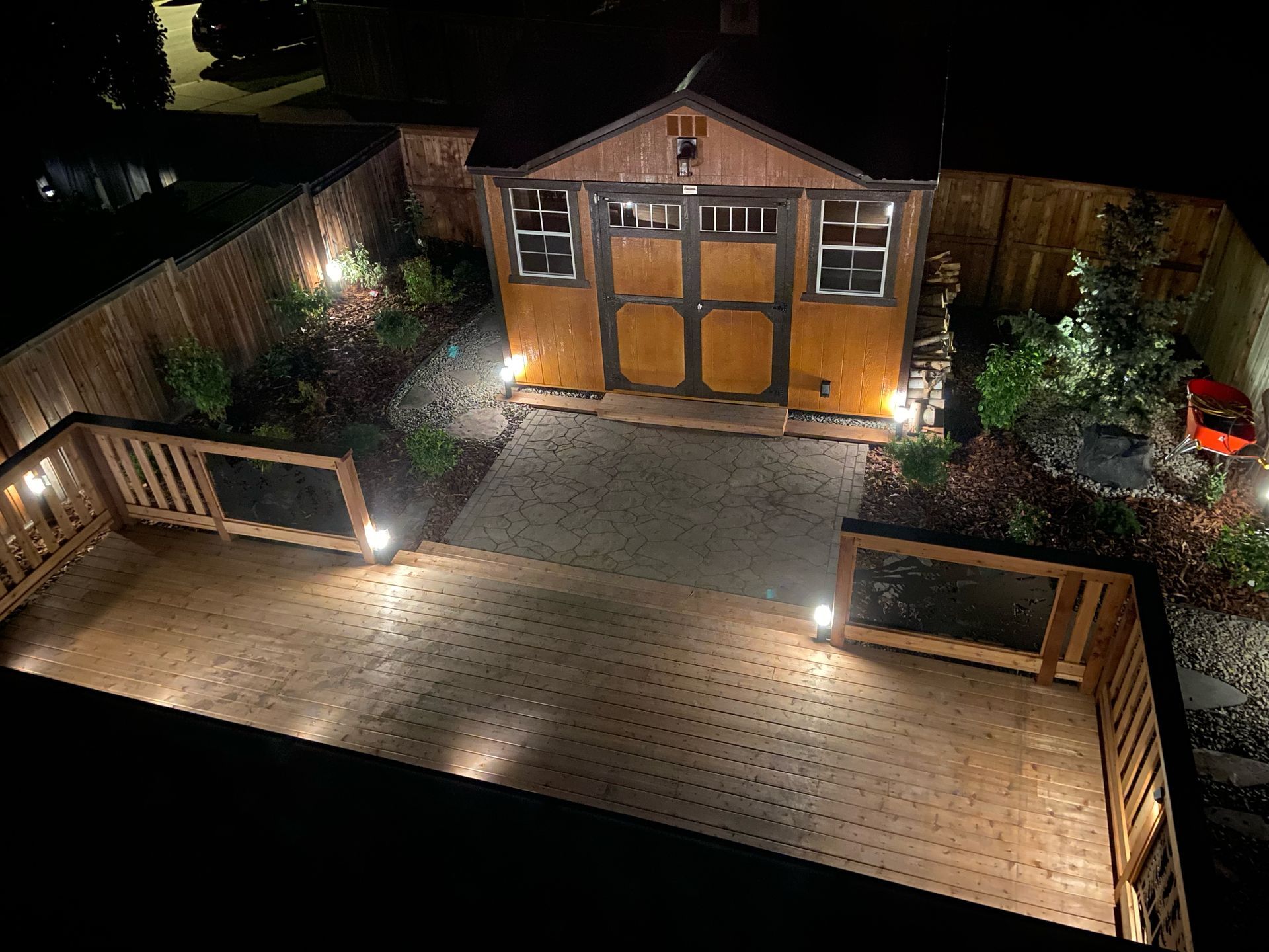 backyard shed with deck and built in lighting