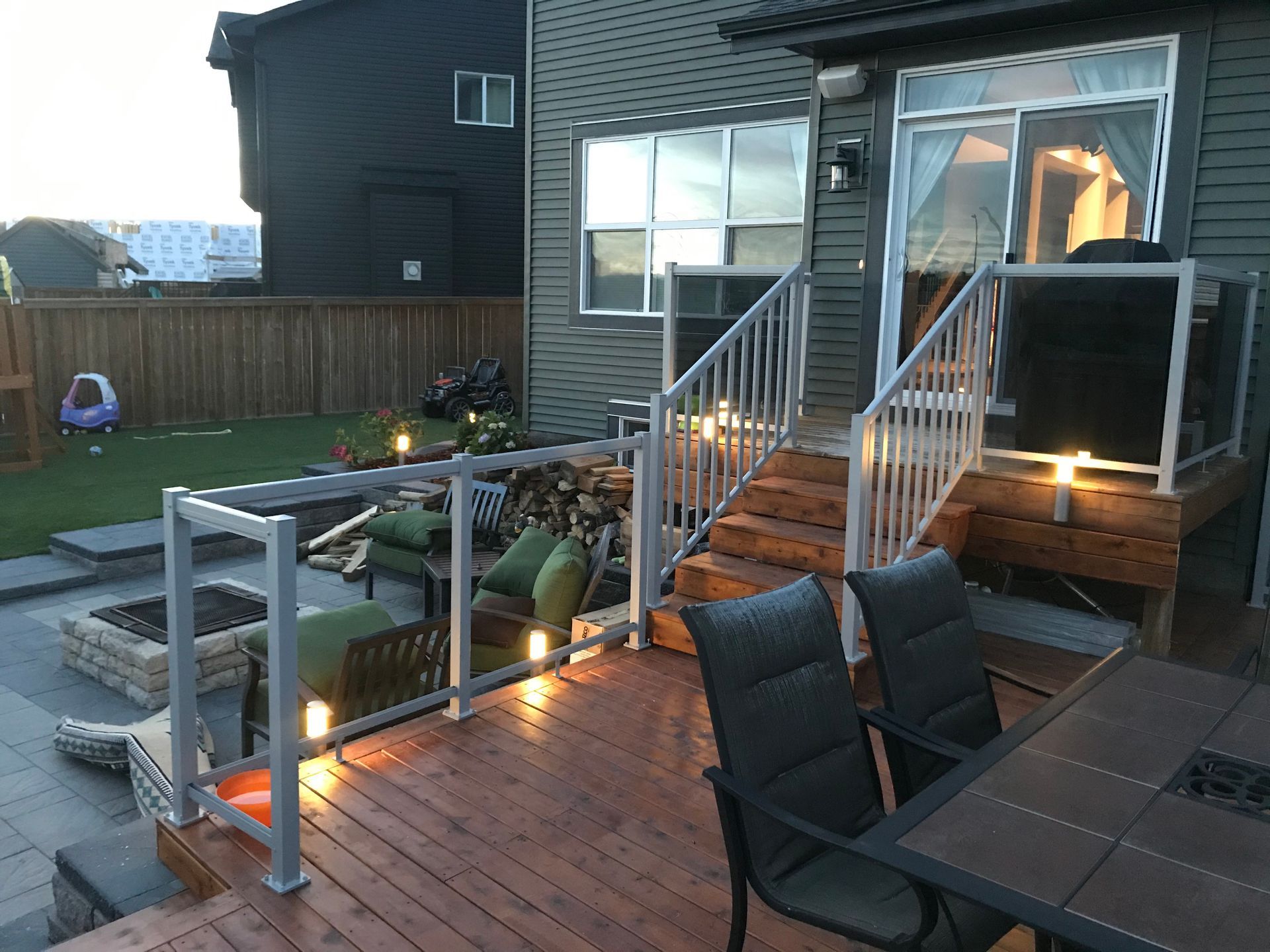 deck with railing leading to stone patio