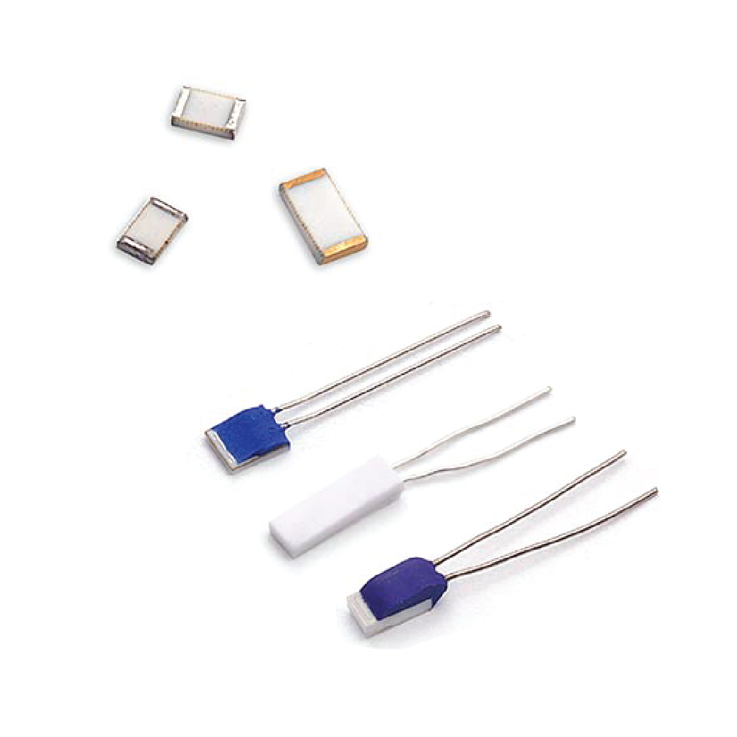 Electronic components: ceramic and epoxy encased thermal fuses with leads, scattered on white.