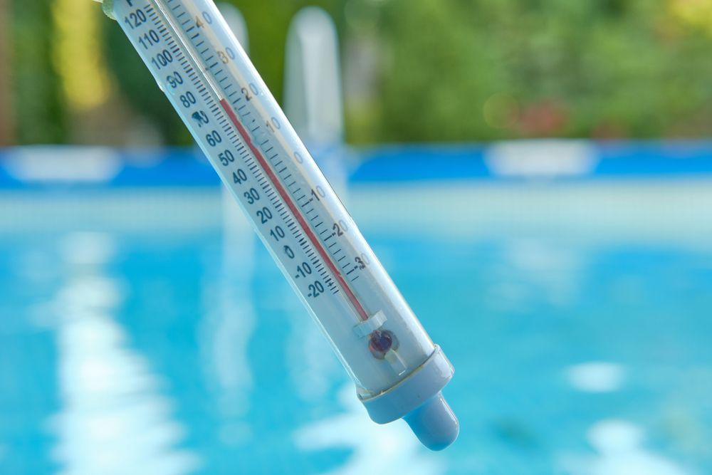 Thermometer in a pool, reading approximately 75 degrees Fahrenheit.