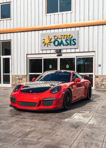 Red sports car parked outside a Great Oasis storefront