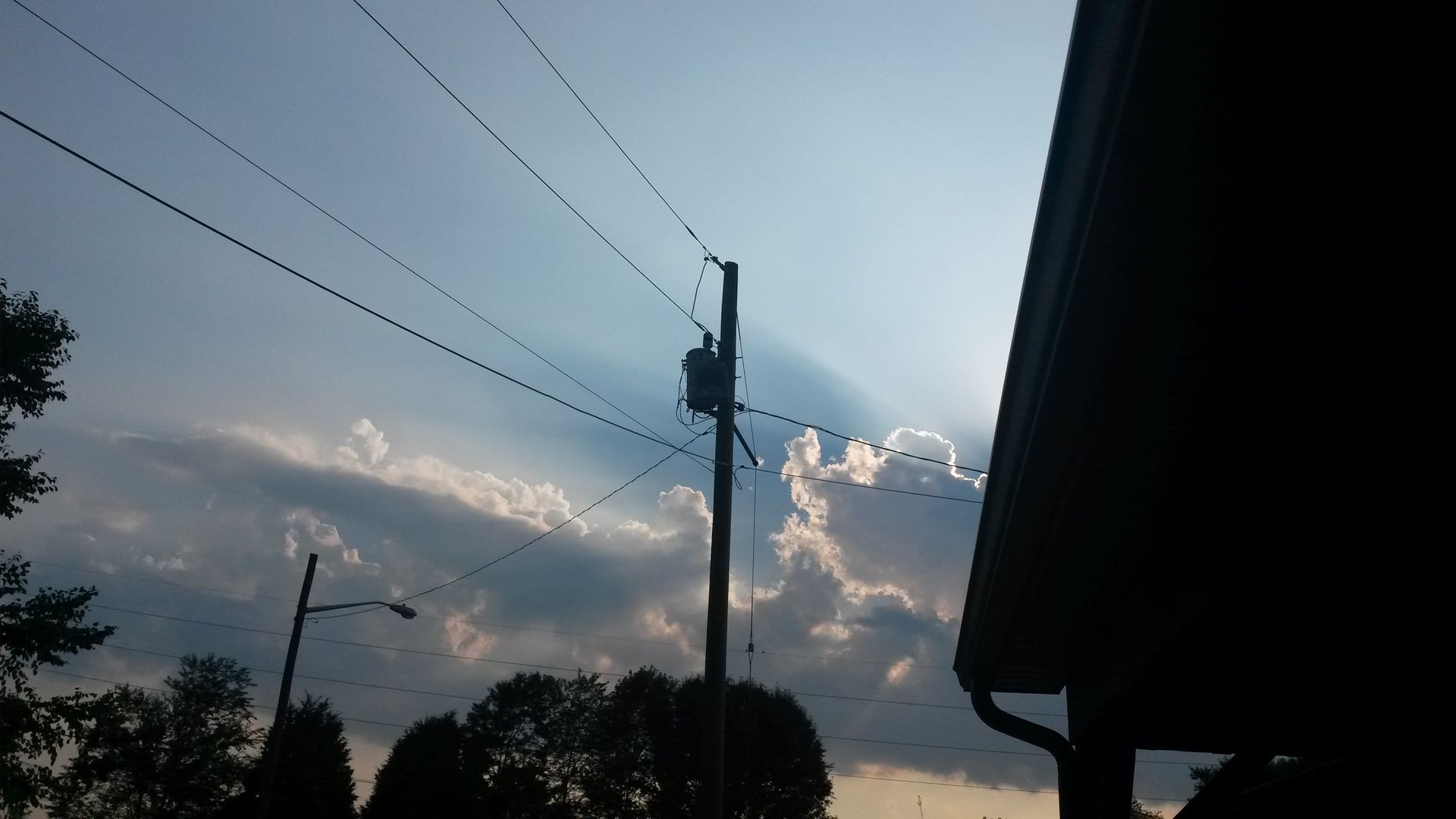 An electrical pole in the middle of the street