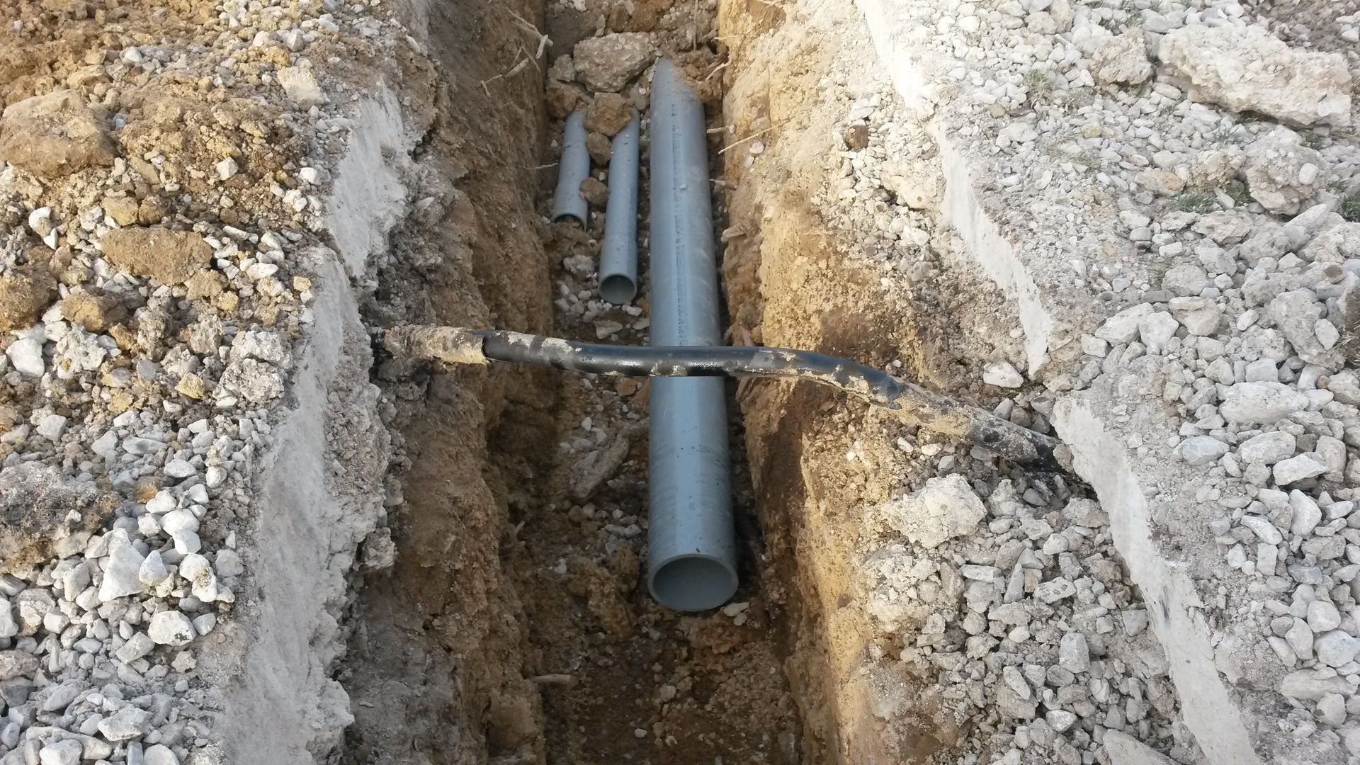 Dug up the whole revealing the piping in the ground