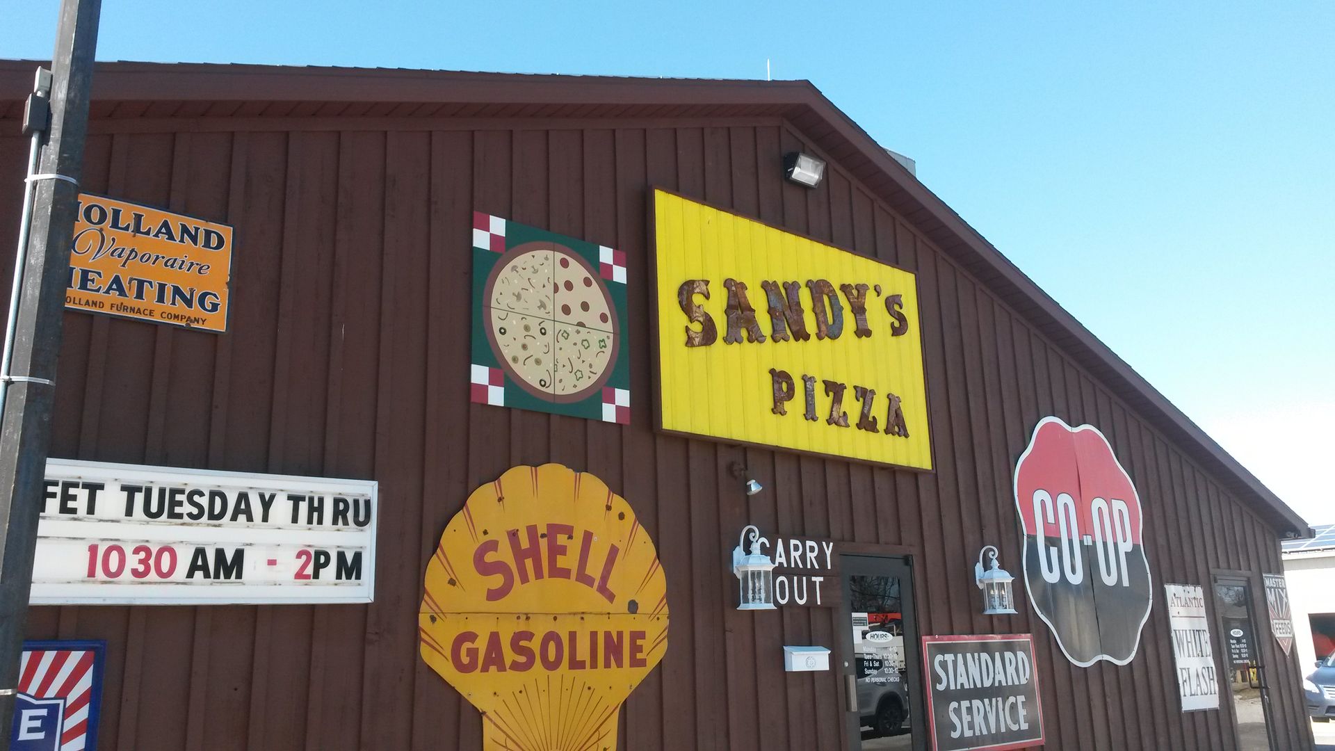 In front of Sandy's Pizza