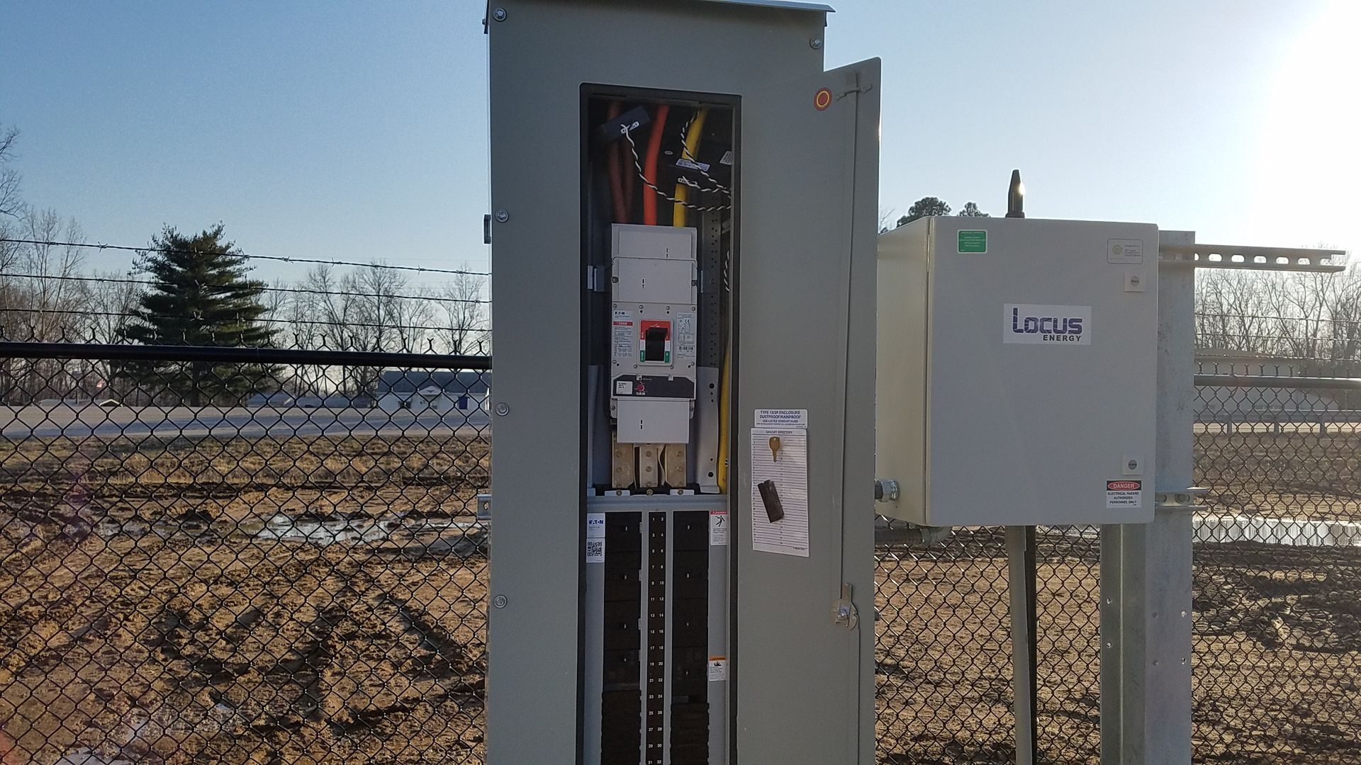 an opened electrical panel showing the wires inside.