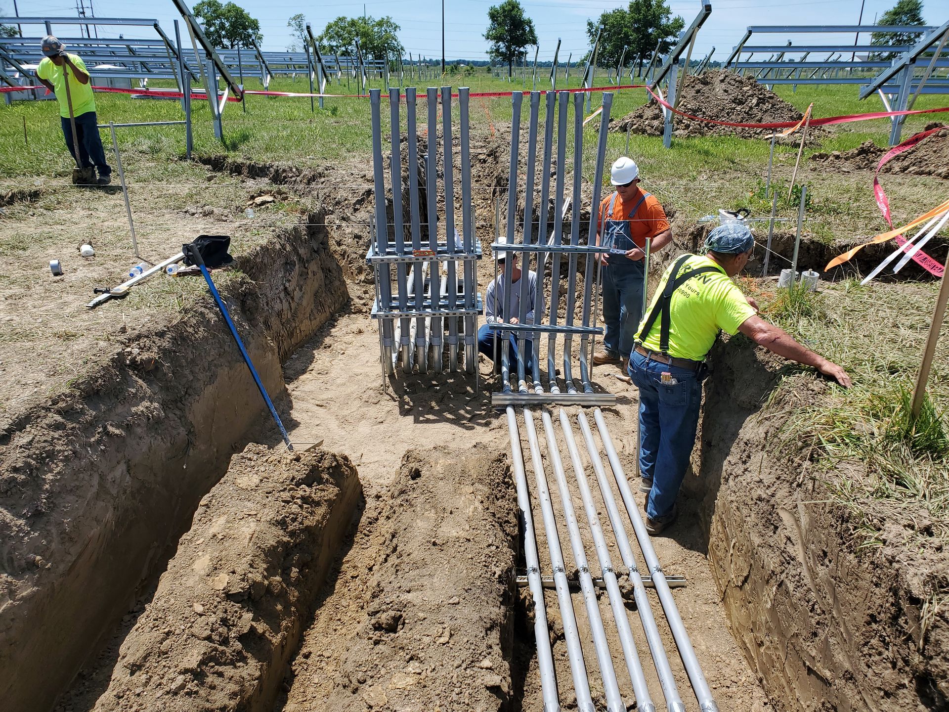 Morton Electric workers are installing metal rods for the construction of an electrical panel.