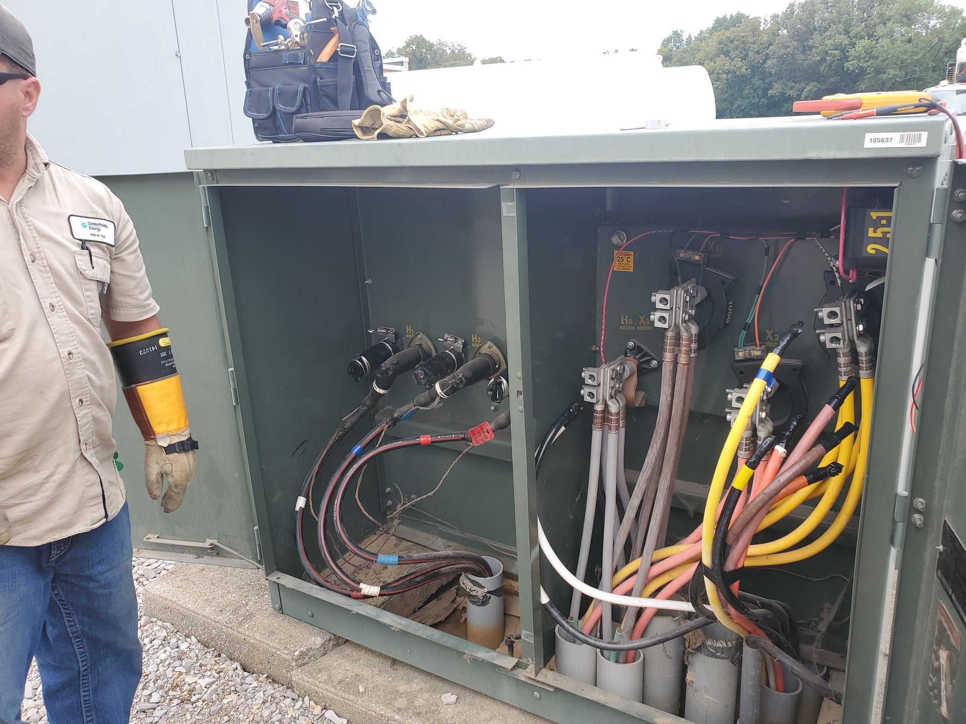 Electrical panel junction box with circuit boards, wires, and connectors, mounted outdoors.