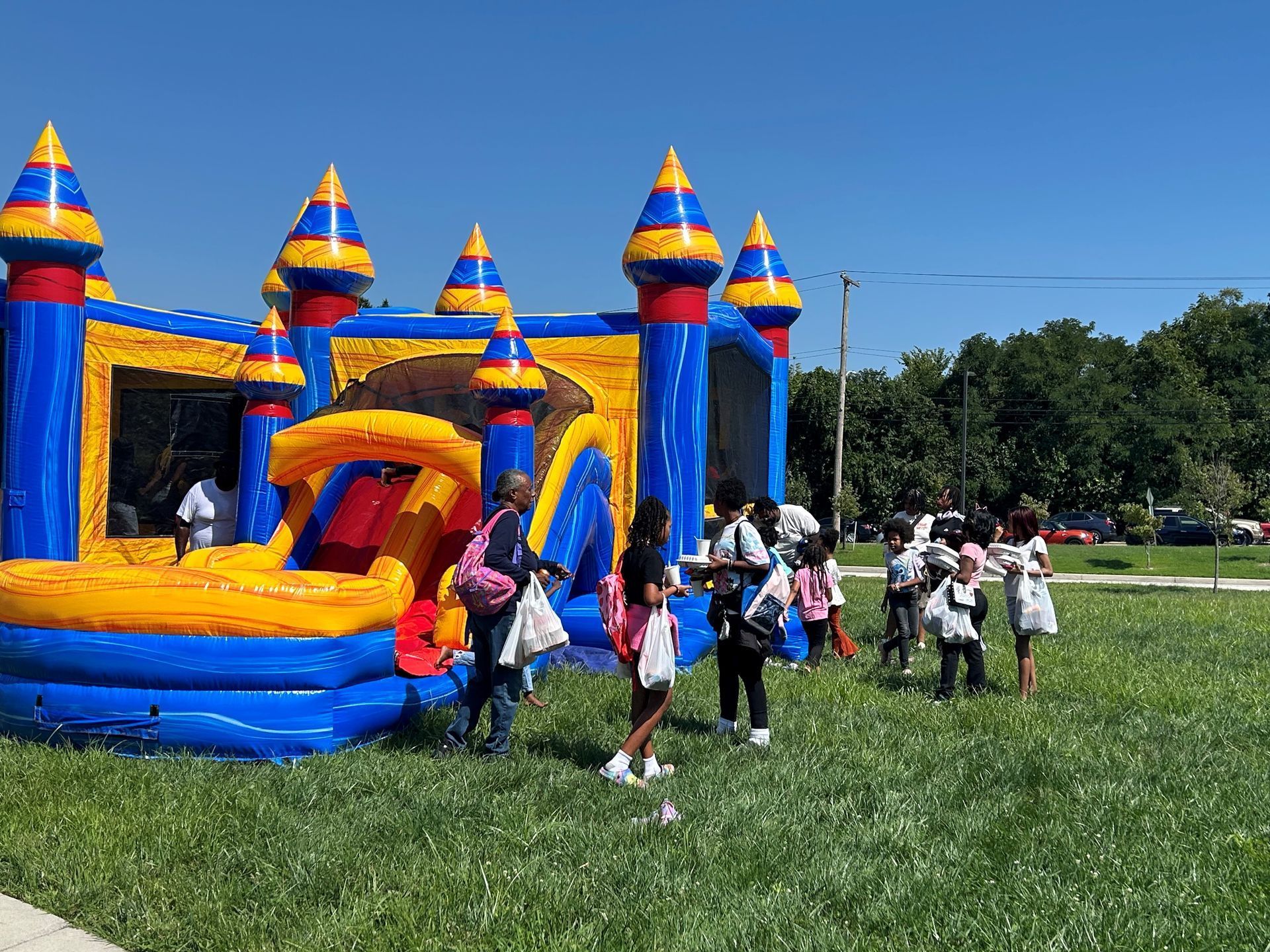 Kids and parents playing on a moon bounce