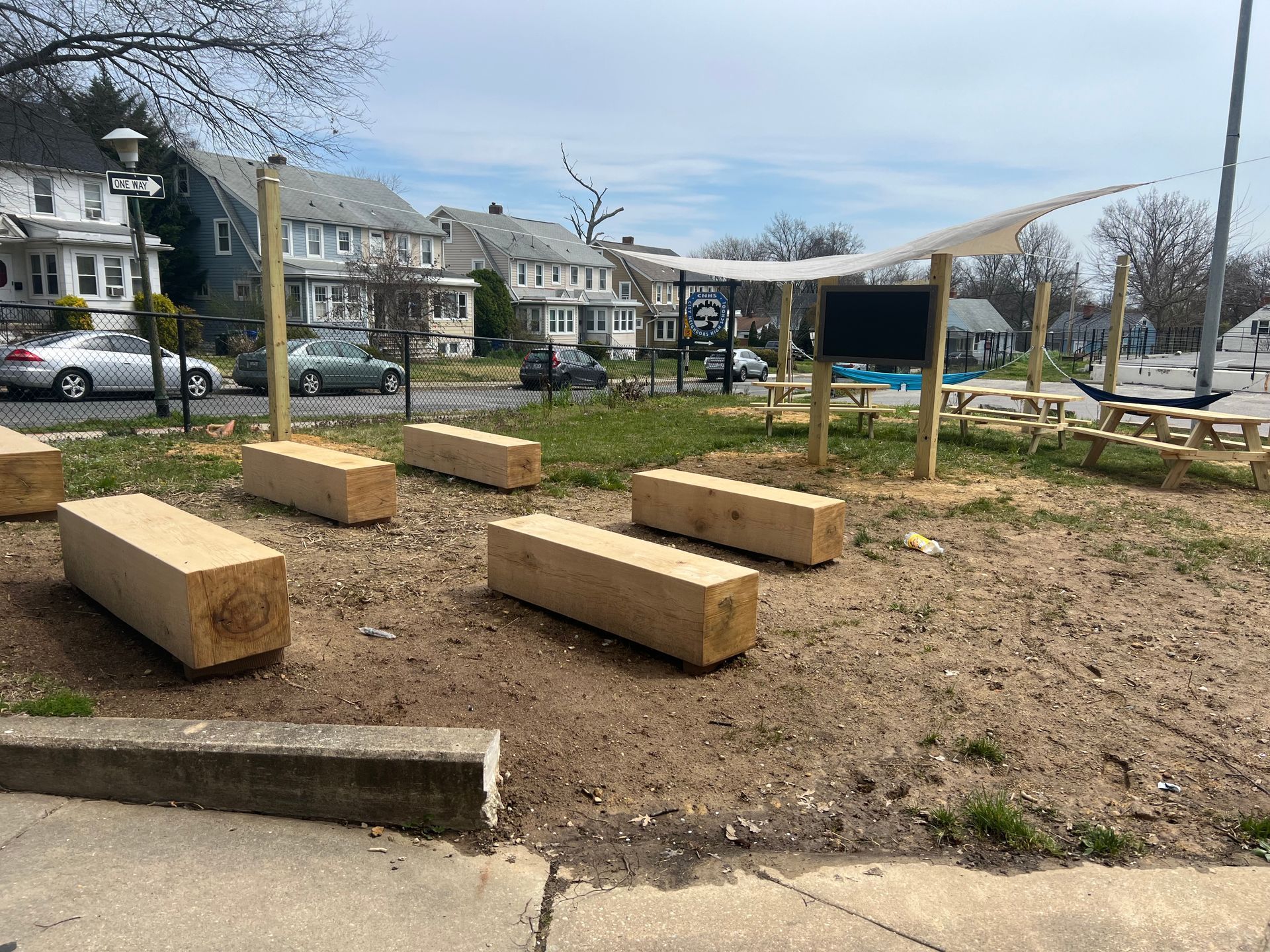 wooden picnic tables on dirt playground