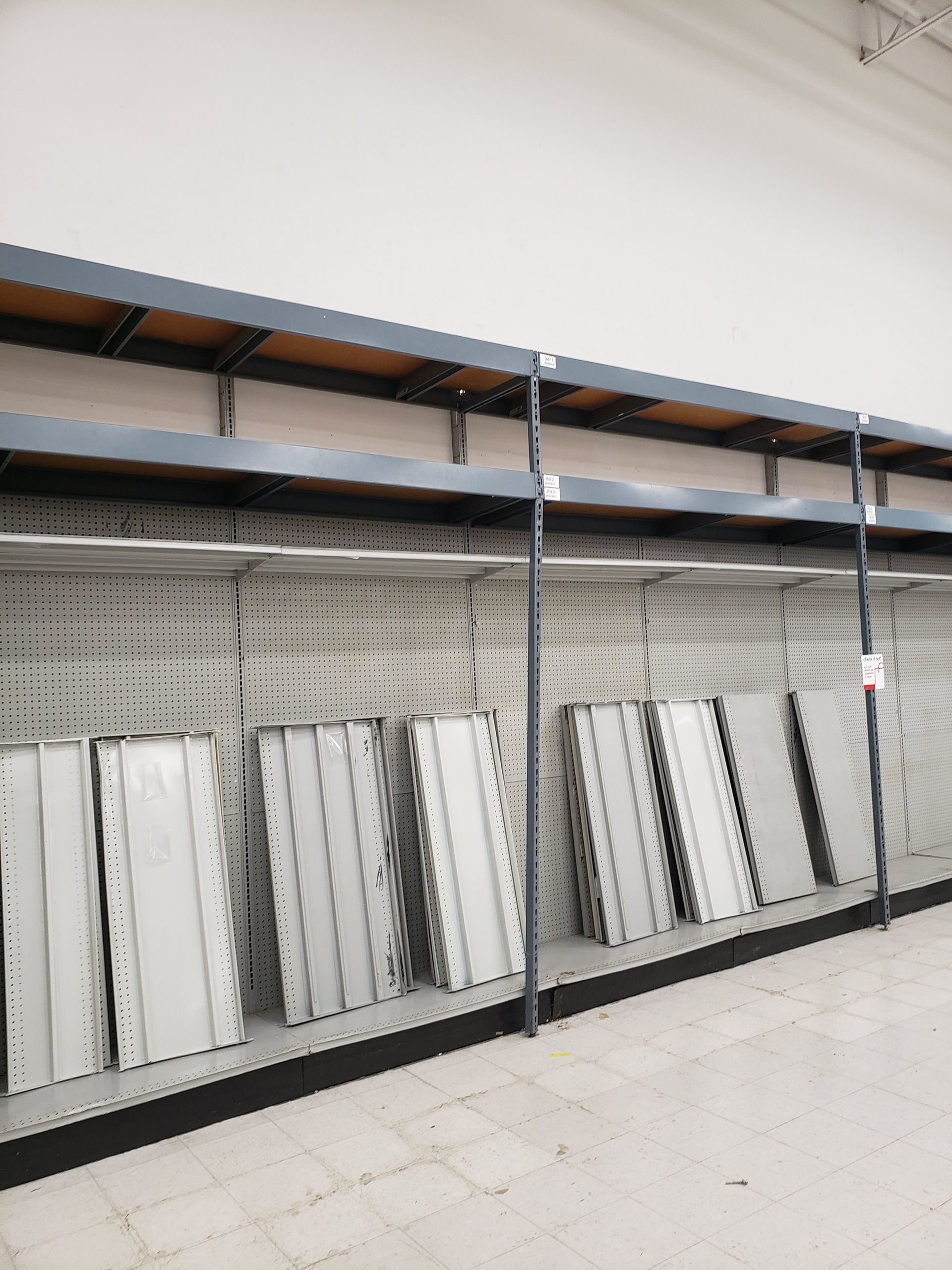 A row of empty shelves in an empty store