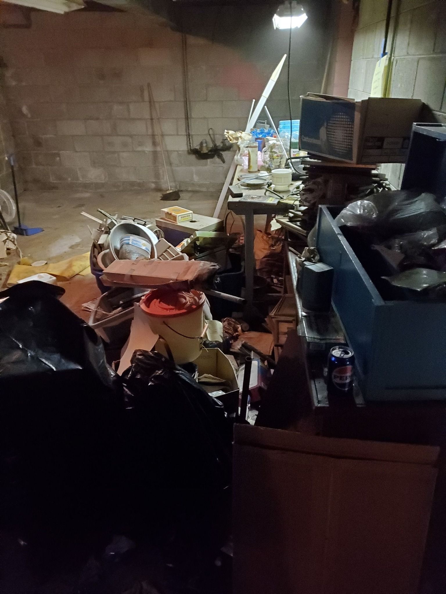 A room filled with lots of trash and boxes.
