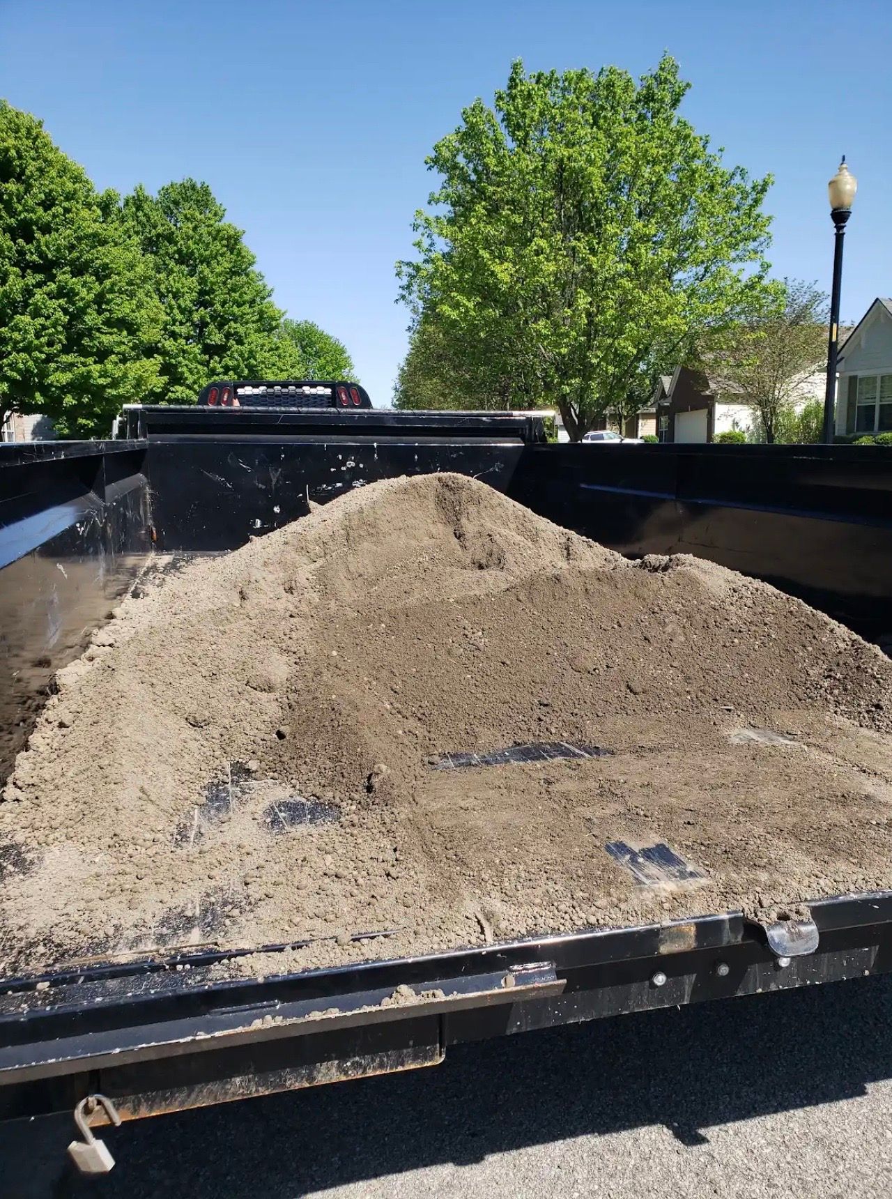 A pile of dirt is in the back of a truck