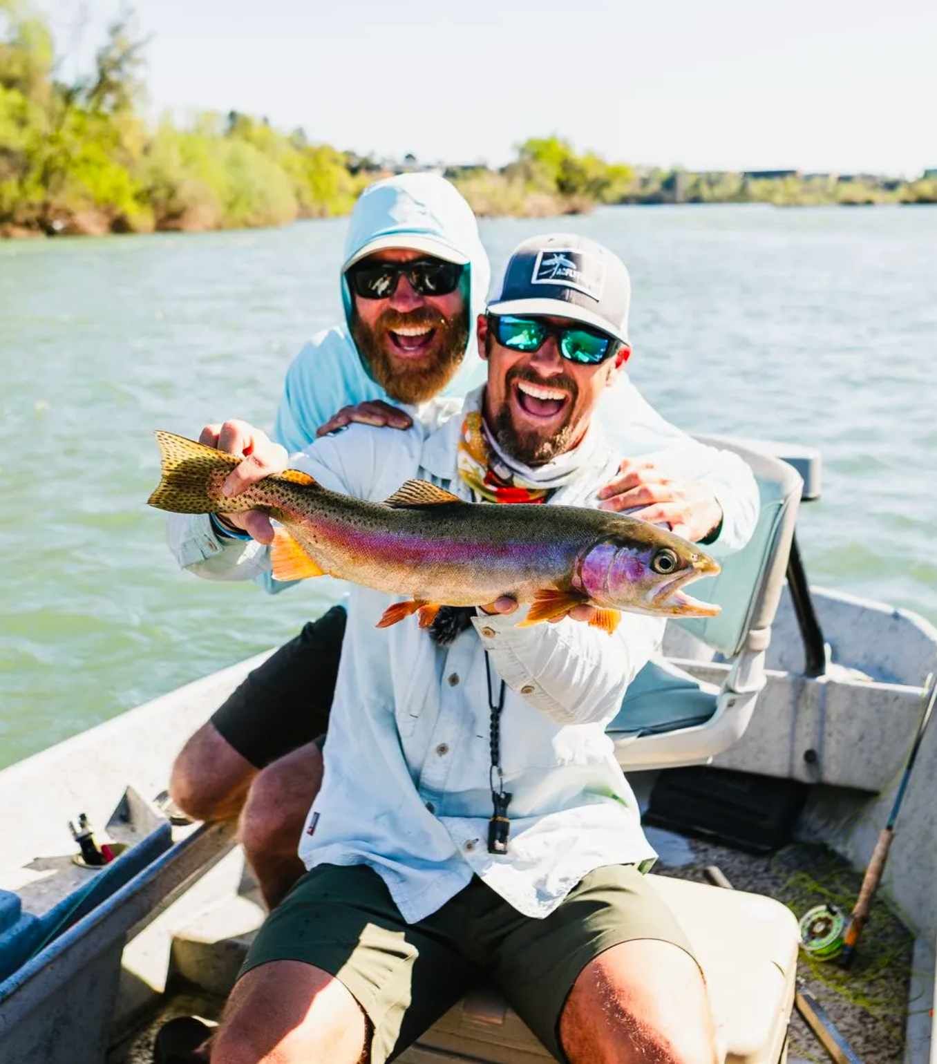 Guide and angler fly fishing on a Redding California river at sunrise
