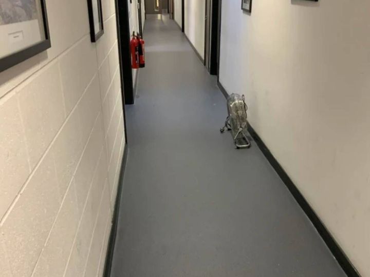 Grey commercial vinyl flooring fitted along a corridor