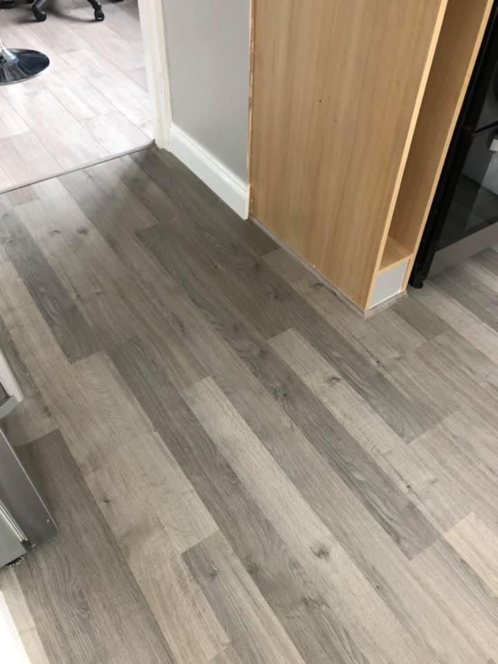 Two different laminate floors fitted in an open plan lounge and kitchen