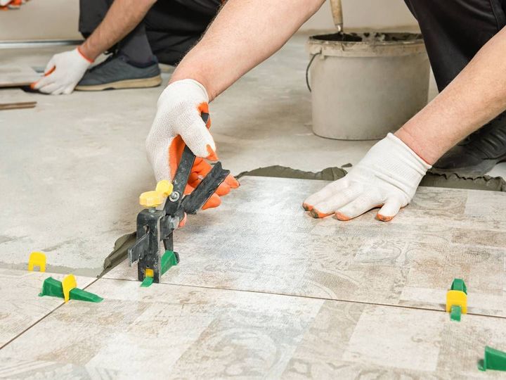 Ceramic floor tiles being fitted in a Derby property