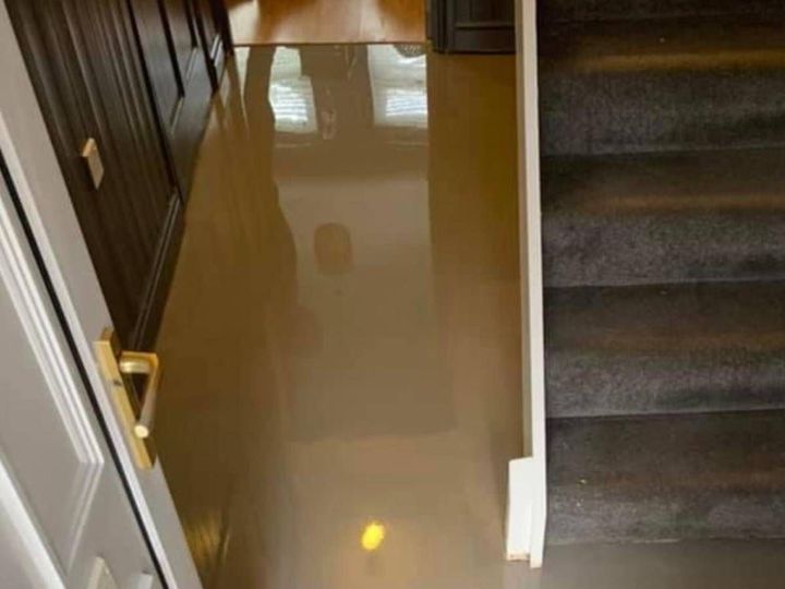 Levelling compound being applied across a hallway floor