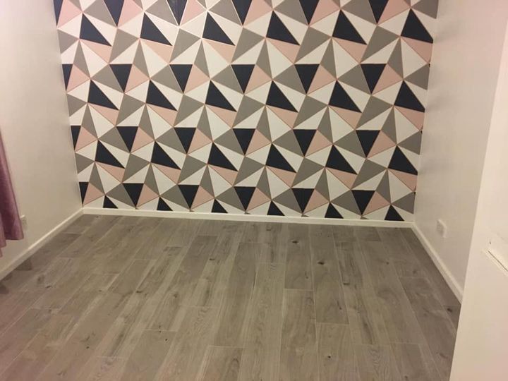 Grey laminate flooring fitted through a living room