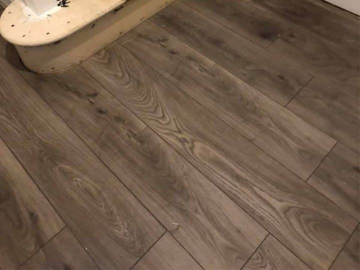 Laminate flooring being fitted through a hallway