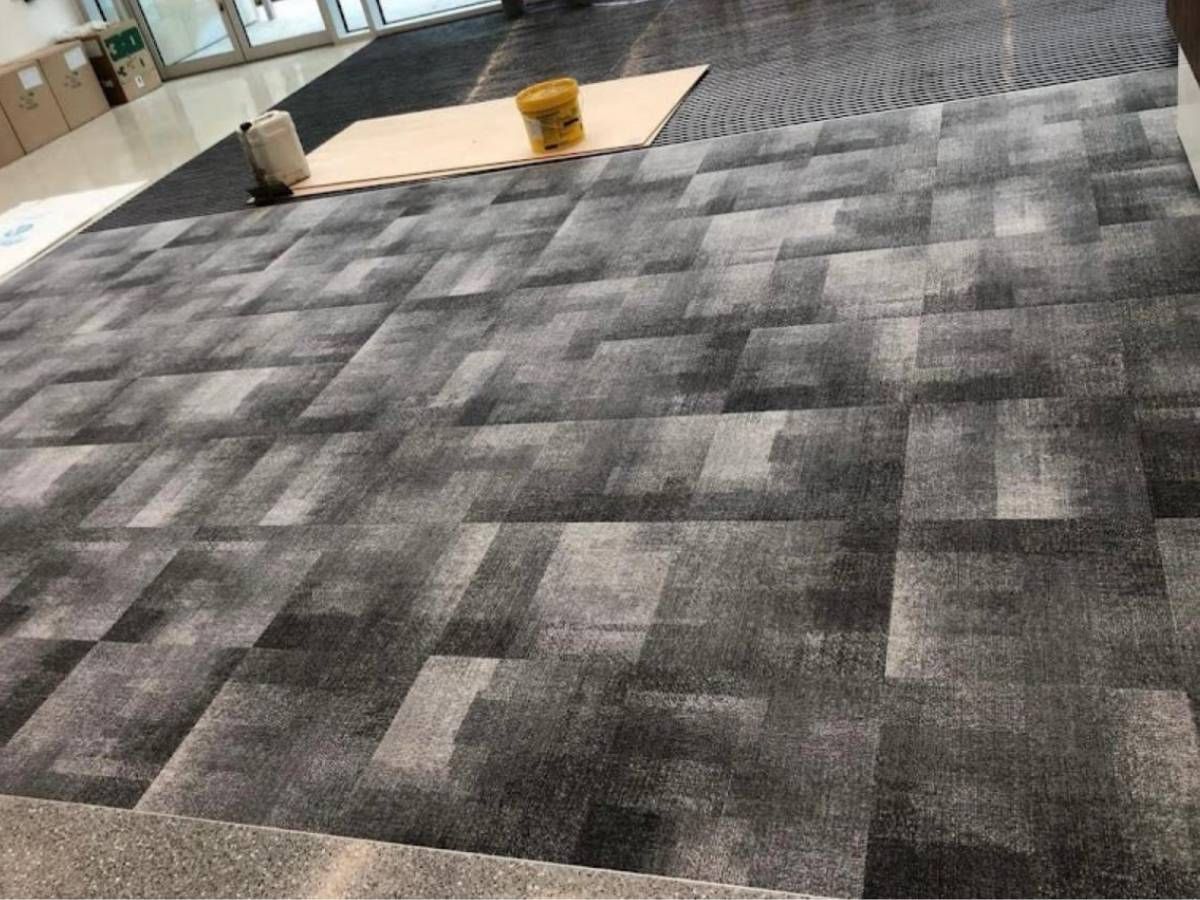 Derbyshire Flooring Specialists fitting carpet tiles for a business in Derby