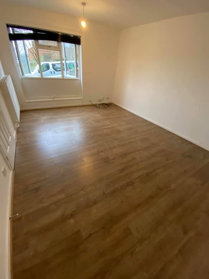 Wood effect laminate flooring fitted through a living room in Derby