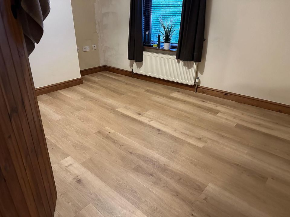 Luxury vinyl tile flooring being installed in a Derby home