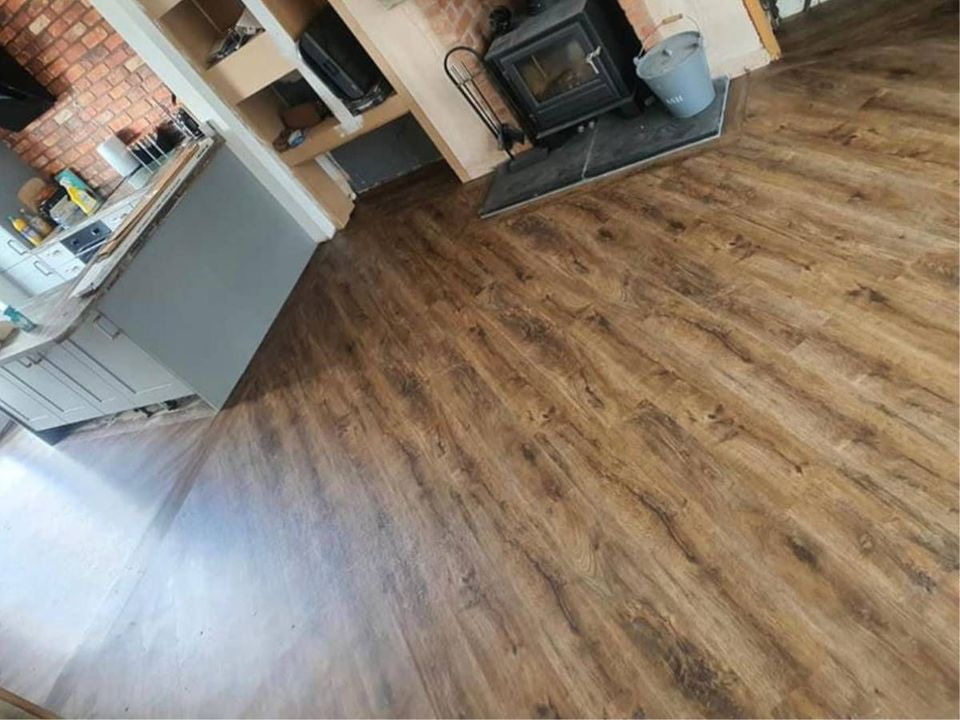 Wood effect luxury vinyl tile flooring fitted in an open plan kitchen and living room