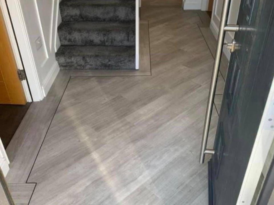 Wood effect luxury vinyl tile flooring fitted through a hallway and kitchen