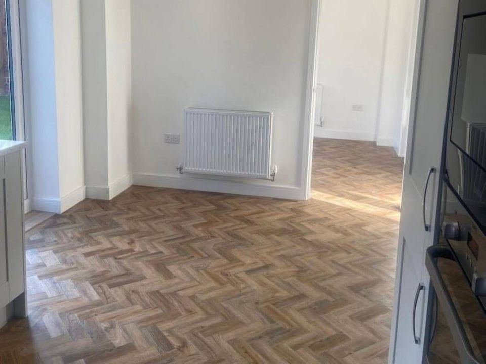 Wood effect herringbone luxury vinyl flooring fitted through a living space