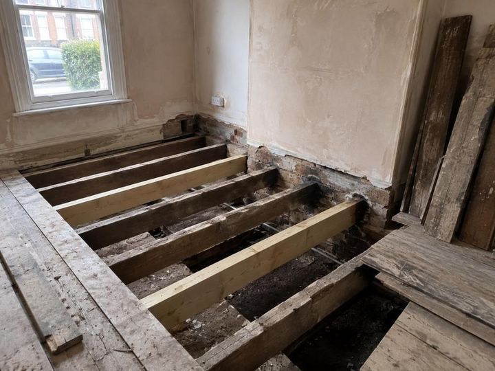 Floor joists exposed beneath a lifted suspended timber floor