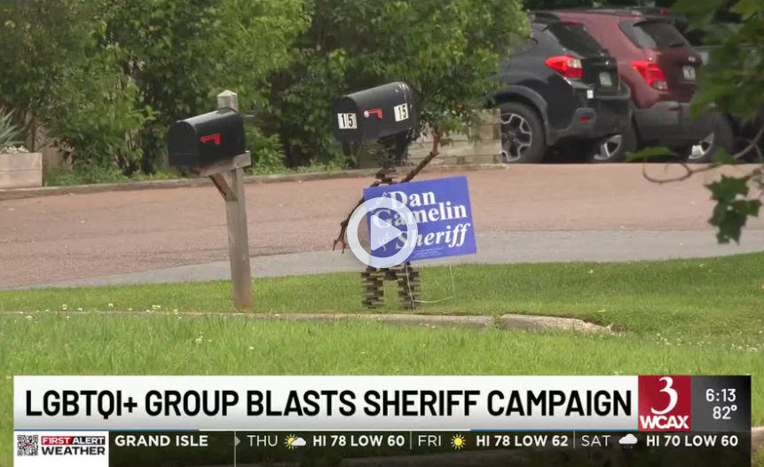 Sheriff campaign sign in a yard; headline reads “LGBTQ+ group blasts sheriff campaign”