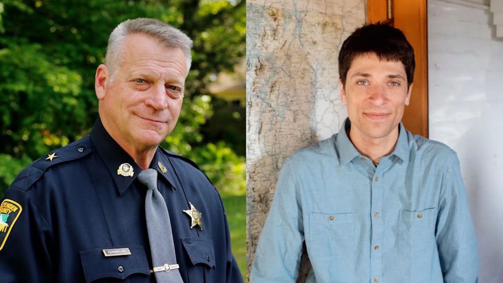 Two men in uniform and a light blue shirt posing outdoors, one beside a tree.
