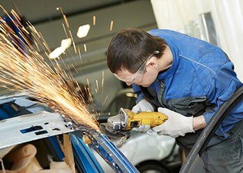 Man Grinding Side of Car – Automotive paint in Bonville, NSW Man Grinding Side of Car – Automotive paint in Bonville, NSW