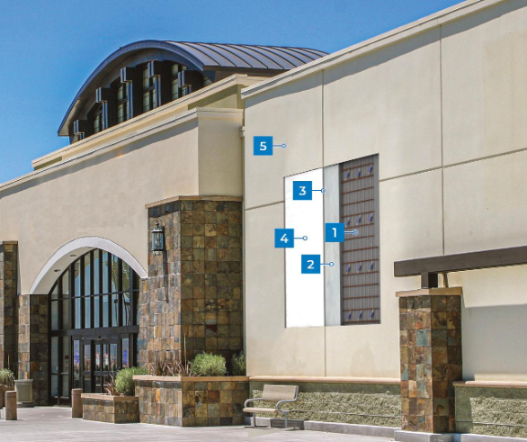“Commercial building with smooth stucco walls, arched entry details, and marked inspection areas after a stucco service in Henderson, NV”