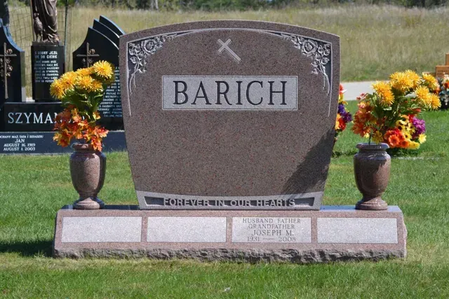 A reddish-brown stone monument with the name 