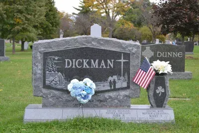 A grey granite tombstone engraved with 