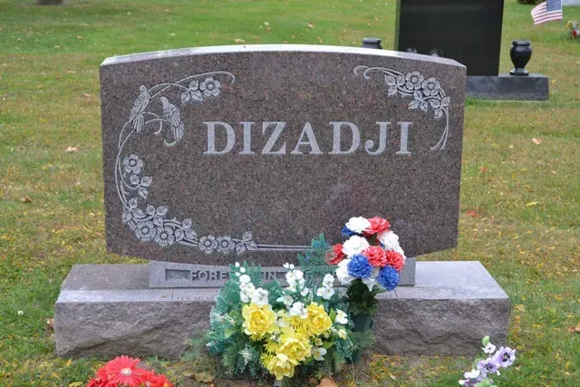 A granite headstone engraved with the surname 