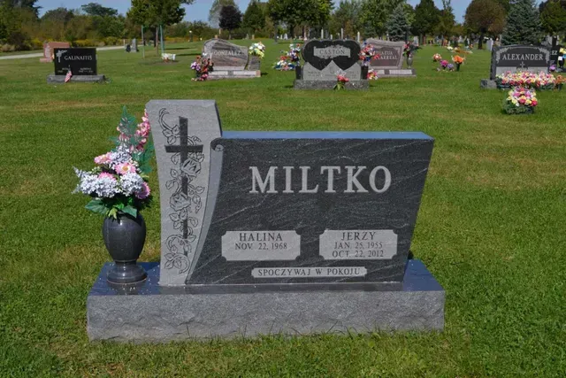 A grey granite headstone marked 