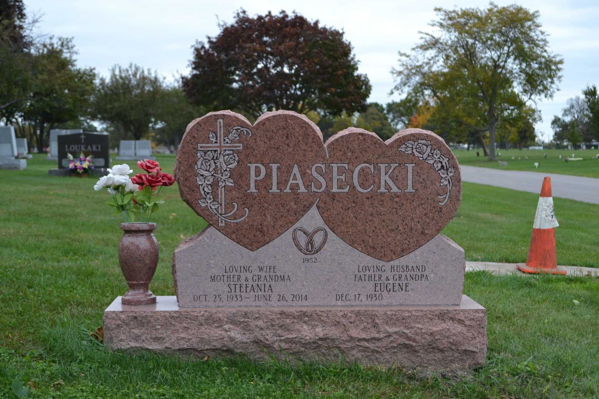 Tombstone shaped as two hearts, inscribed 