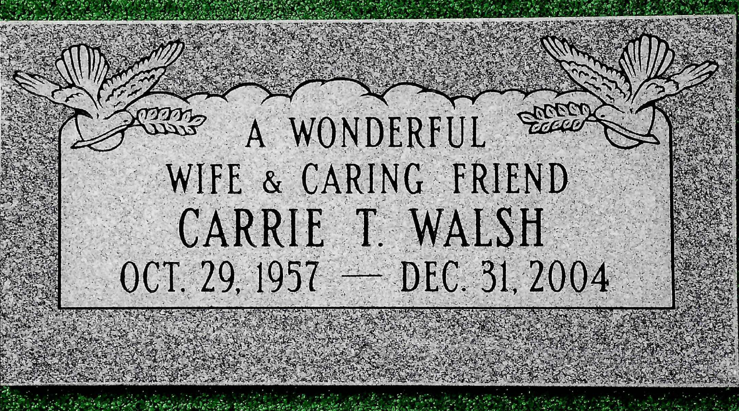 A flat, grey granite headstone for Carrie T. Walsh (1957–2004), engraved with