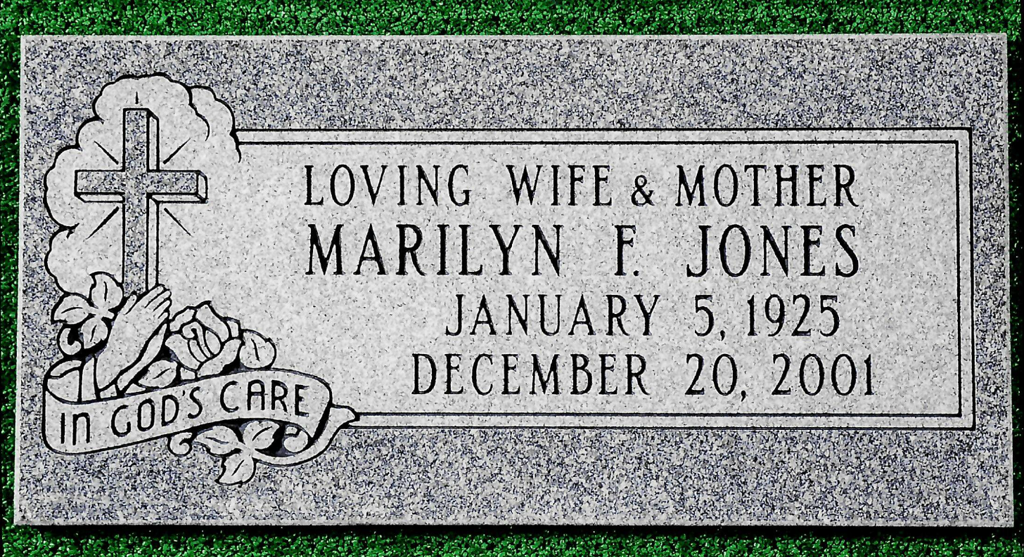 A grey granite grave marker inscribed