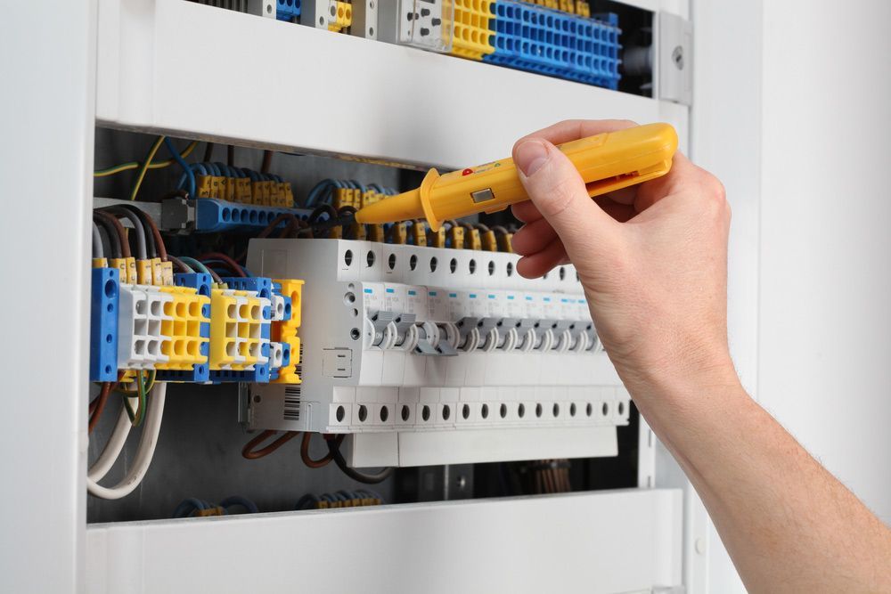 A Person is Working on an Electrical Box With a Screwdriver — Brite-Lec Pty Ltd in Currajong, QLD