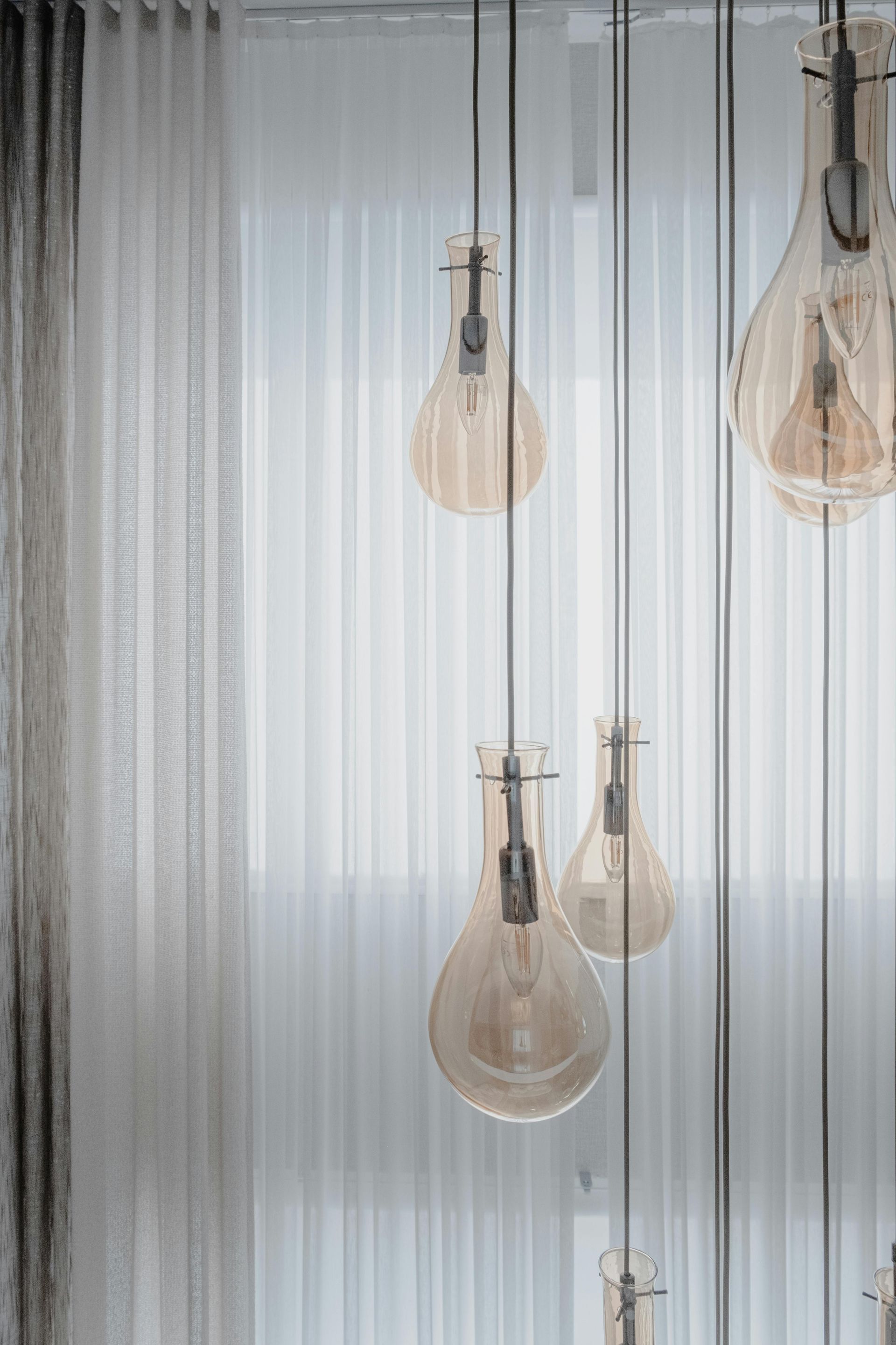 A Bunch Of Light Bulbs Hanging From The Ceiling In A Room.