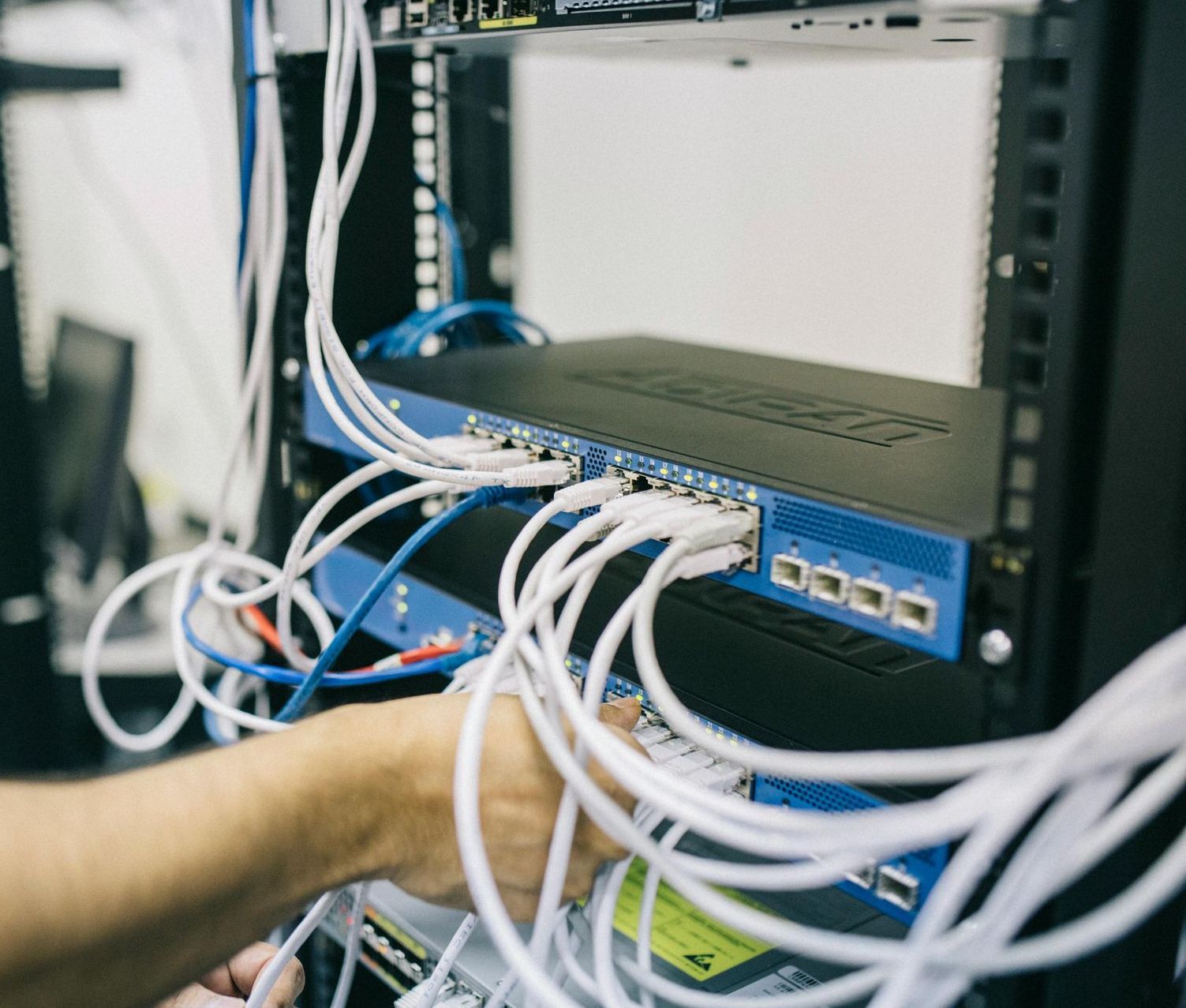 A Person Is Working On A Server In A Data Center.