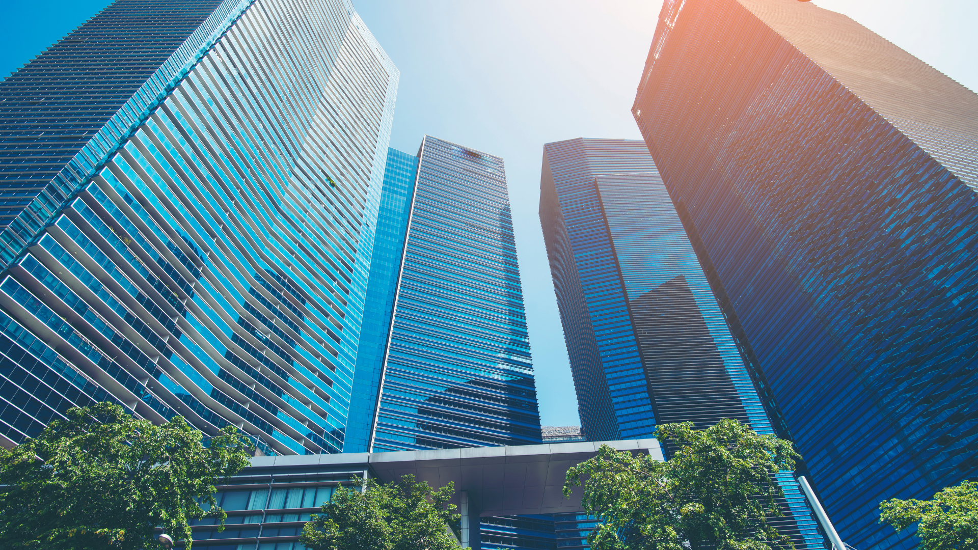 a group of tall buildings against a blue sky .