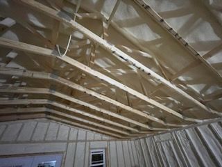 The ceiling of a house is being built with wooden beams.