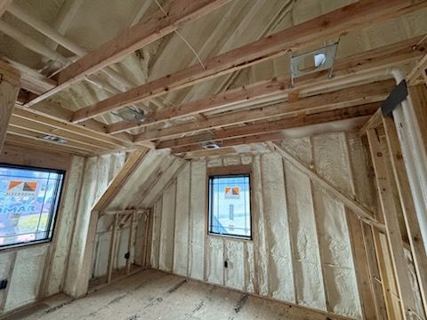 A room in a house under construction with foam on the walls and ceiling.