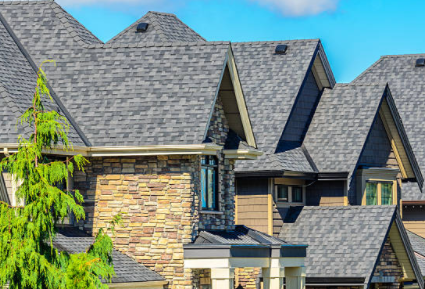 A large house with a lot of windows and a roof.