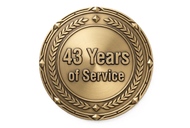 Gold circular service award medal reading “43 Years of Service” with laurel wreath border